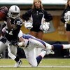 OAKLAND, CA - NOVEMBER 12:  Fabian Washington #27 of the Oakland Raiders makes a reception against pressure from Rod Smith #80 of the Denver Broncos during an NFL game at McAfee Coliseum on November 12, 2006 in Oakland, California.  (Photo by Jed Jacobsoh
