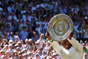 WIMBLEDON, ENGLAND - JULY 04:  Serena Williams of USA celebrates with the Championship trophy after the women's singles final match against Venus Williams of USA on Day Twelve of the Wimbledon Lawn Tennis Championships at the All England Lawn Tennis and C