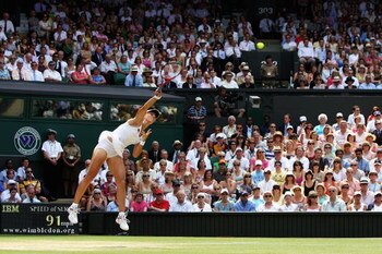 WIMBLEDON, ENGLAND - JULY 02:  Elena Dementieva of Russia serves during the women's singles semi final match against Serena Williams of USA on Day Ten of the Wimbledon Lawn Tennis Championships at the All England Lawn Tennis and Croquet Club on July 2, 20