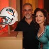 NASHVILLE, TN - JUNE 22: Emilio Estefan and Gloria Estefan pose with their team The Miami Dolphins helmet before joining Hank Williams Jr. to sing 'Are You Ready for some Football' in Spanish as part of the 40th Anniversary of Monday Night Football at Cen