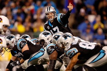 CHARLOTTE, NC - JANUARY 10:  Quarterback Jake Delhomme #17 of the Carolina Panthers signals to a teammate while lined up against the Arizona Cardinals defense during the NFC Divisional Playoff Game on January 10, 2009 at Bank of America Stadium in Charlot