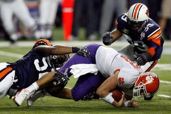 ATLANTA - DECEMBER 31:  Antonio Coleman #52 and Chris Evans #59 of the Auburn University Tigers tackle Cullen Harper #10 of the Clemson University Tigers during the Chick-Fil-A Bowl on December 31, 2007 at the Georgia Dome in Atlanta, Georgia.  (Photo by 