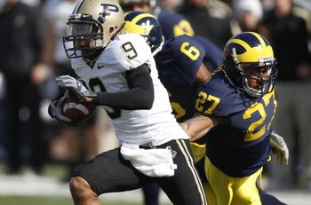 ANN ARBOR, MI - OCTOBER 13: Dorien Bryant #9 of the Purdue Boilermakers avoids the tackle by Brandon Harrison #27 of the Michigan Wolverines during a first quarter kickoff return on October 13, 2007 at Michigan Stadium in Ann Arbor, Michigan. (Photo By Gr