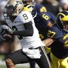 ANN ARBOR, MI - OCTOBER 13: Dorien Bryant #9 of the Purdue Boilermakers avoids the tackle by Brandon Harrison #27 of the Michigan Wolverines during a first quarter kickoff return on October 13, 2007 at Michigan Stadium in Ann Arbor, Michigan. (Photo By Gr