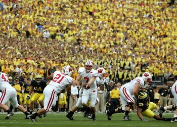 ANN ARBOR, MI - SEPTEMBER 23:  John Stocco #7 of the Wisconsin Badgers hands off to Dywon Rowan #21 against the Michigan Wolverines on September 23, 2006 at Michigan Stadium in Ann Arbor, Michigan. Michigan defeated Wisconsin 27-13.  (Photo by Jonathan Da