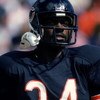 Walter Payton #34 of the Chicago Bears holds the ball during a game.