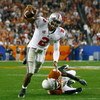 GLENDALE, AZ - JANUARY 05:  Quarterback Terrelle Pryor #2 of the Ohio State Buckeyes scrambles with the ball under pressure from Ryan Palmer #13 of the Texas Longhorns during the Tostitos Fiesta Bowl Game on January 5, 2009 at University of Phoenix Stadiu