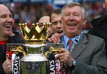 MANCHESTER, ENGLAND - MAY 16:  Manchester United Manager Sir Alex Ferguson (R) and Assistant Mike Phelan celebrate with the Barclays Premier League trophy after their side won the Premier League title at the end of the Barclays Premier League match betwee