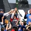 CHICAGO - MAY 02: Fans in the left field bleachers try to catch a home run ball hit by Cody Ross of the Florida Marlins in the 5th inning against the Chicago Cubs on May 2, 2009 at Wrigley Field in Chicago, Illinois. The Cubs defeated the MArlins 6-1. (Ph