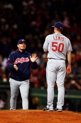 BOSTON - OCTOBER 13:  Jensen Lewis #50 of the Cleveland Indians stands on the mound as manager Eric Wedge walks in to pull him from the game in the seventh inning against the Boston Red Sox during Game Two of the American League Championship Series at Fen