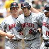 OAKLAND, CA - JUNE 11:  Joe Crede #24 of the Minnesota Twins is congratulated by Jason Kubel #16 and Justin Morneau #33 after hitting a home run in the fourth inning against the Oakland Athletics during a Major League Baseball game on June 11, 2009 at the
