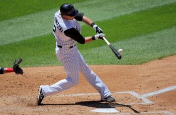 DENVER - JULY 08:  Troy Tulowitzki #2 of the Colorado Rockies makes contact as he takes an at bat against the Washington Nationals during MLB action at Coors Field on July 8, 2009 in Denver, Colorado. The Rockies defeated the Nationals 10-4.  (Photo by Do