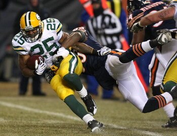 CHICAGO - DECEMBER 22: Ryan Grant #25 of the Green Bay Packers tries to break away from Nick Roach #53 of the Chicago Bears on December 22, 2008 at Soldier Field in Chicago, Illinois. (Photo by Jonathan Daniel/Getty Images)