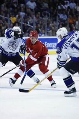 LOS ANGELES - OCTOBER 12:  Center Igor Larionov #8 of the Detroit Red Wings drives to the net while being defended by the Los Angeles Kings during the game at Staples Center on October 12, 2002 in Los Angeles, California. (Photo by Victor Decolongon/Getty