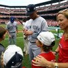 ST LOUIS, MO - JULY 14:  Derek Jeter of the New York Yankees signs autographs for young fans as musician Sheryl Crow looks on before the 2009 MLB All-Star Game at Busch Stadium on July 14, 2009 in St Louis, Missouri.  (Photo by Jamie Squire/Getty Images)