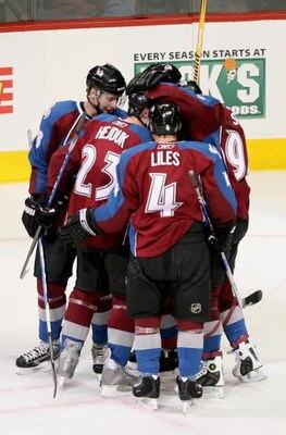 DENVER - JANUARY 18:  Milan Hejduk #23 of the Colorado Avalanche is congratulated by his teammates Wojtek Wolski #8, John-Michael Liles #4 and Ryan Smyth #94 after scoring his 300th NHL career goal on goaltender Curtis McElhinney of the Calgary Flames in 