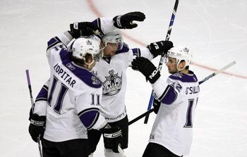 CHICAGO - MARCH 01: Anze Kopitar #11, Jack Johnson #3 and Patrick O'Sullivan #12 of the Los Angeles Kings celebrate a first period goal against the Chicago Blackhawks on March 1, 2009 at the United Center in Chicago, Illinois. The Blackhawks defeated the 