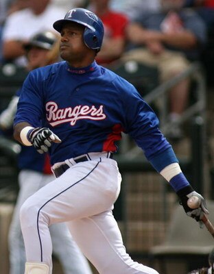 SURPRISE, AZ - MARCH 07:  Sammy Sosa #21 of the Texas Rangers hits a three run homerun against the Arizona Diamondbacks during the third inning of the MLB spring training game at Surprise Stadium on March 7, 2007 in Surprise, Arizona.  (Photo by Christian