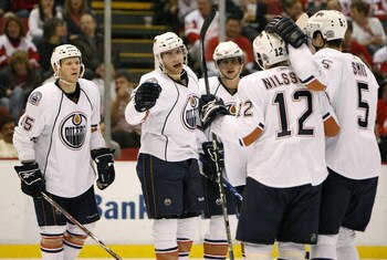 DETROIT - FEBRUARY 07: Marc Pouliot #78 of the Edmonton Oilers celebrates his third period goal with Robert Nisson #12, Ladislav Smid #5, Denis Grebeshkov #37 and Liam Reddox #85 while playing the Detroit Red Wings on February 7, 2009 at Joe Louis Arena i