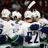 CHICAGO - MAY 05:  (L-R) Henrik Sedin #33, Steve Bernier #18, Daniel Sedin #22 and Alexander Edler #23 of the Vancouver Canucks celebrate after Bernier scored a goal in the third period against the Chicago Blackhawks during Game Three of the Western Confe