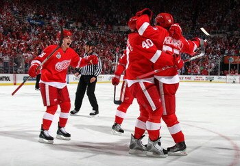 DETROIT - JUNE 06:  Niklas Kronwall #55 of the Detroit Red Wings celebrates with Jiri Hudler #26 and Henrik Zetterberg after scoring a goal in the second period against the Pittsburgh Penguins during Game Five of the 2009 NHL Stanley Cup Finals at Joe Lou