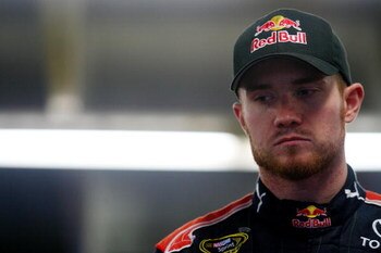 CONCORD, NC - OCTOBER 15:  Brian Vickers, driver of the #83 Red Bull Toyota, stands in the garage during practice for the NASCAR Sprint Cup Series NASCAR Banking 500 at Lowe's Motor Speedway on October 15, 2009 in Concord, North Carolina.  (Photo by Jason