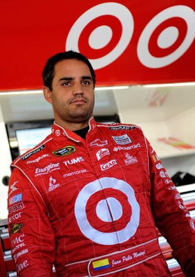 KANSAS CITY, KS - OCTOBER 02: Juan Pablo Montoya, driver of the #42 Target Chevrolet stands in the garage while adjustments are made to his car during practice for the NASCAR Sprint Cup Series Price Chopper 400 presented by Kraft Foods at the Kansas Speed