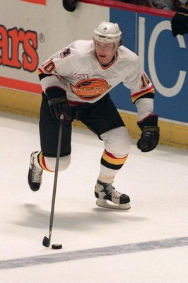 13 Apr 1994:  Forward Pavel Bure of the Vanouver Canucks skates along the boards with the puck during the Canucks game versus the Anaheim Ducks at the Arrowhead Pond in Anaheim, California. Mandatory Credit: Al Bello/Allsport