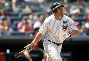 NEW YORK - JULY 04:  Johnny Damon #18 of the New York Yankees hits a  two run home run in the seventh against the Toronto Blue Jays on July 4, 2009 at Yankee Stadium in the Bronx borough of New York City.  (Photo by Nick Laham/Getty Images)