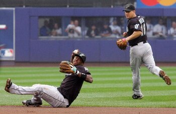 NEW YORK - SEPTEMBER 27:  Hanley Ramirez #2 of the Florida Marlins throws to first for an out against Carlos Delgado (not pictured) of the New York Mets in the sixth inning as teammate Wes Helms #18 looks on on September 27, 2008 at Shea Stadium in the Fl