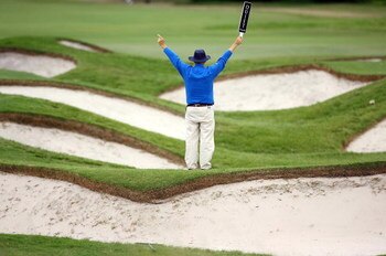 SYDNEY, AUSTRALIA - DECEMBER 14: A course official tries to hush the crowd on the third hole during the fourth round of the 2008 Australian Open at The Royal Sydney Golf Club on December 14, 2008 in Sydney, Australia.  (Photo by Mark Nolan/Getty Images)