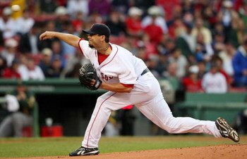BOSTON - JULY 07:  Josh Beckett #19 of the Boston Red Sox delivers a pitch in the first inning against the Oakland Athletics on July 7, 2009 at Fenway Park in Boston, Massachusetts.  (Photo by Elsa/Getty Images)
