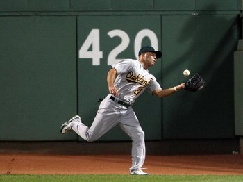 BOSTON - JULY 06:  Scott Hairston #21 of the Oakland Athletics bobbles a hit by Jason Bay of the Boston Red Sox on July 6, 2009 at Fenway Park in Boston, Massachusetts. The Athletics defeated the Red Sox 6-0. (Photo by Elsa/Getty Images)