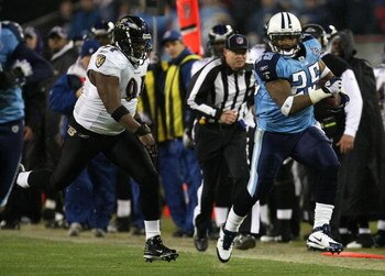 NASHVILLE, TN - JANUARY 10:  Running back LenDale White #25 of the Tennessee Titans runs the ball down the sideline by Marques Douglas #91 of the Baltimore Ravens in the third quarter during the AFC Divisional Playoff Game on January 10, 2009 at LP Field 