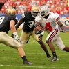 TEMPE, AZ - JANUARY 02:  Wire receiver Santonio Holmes #4 of the Ohio State Buckeyes runs after a catch as he looks to get by defensive back Tom Zbikowski #9 of the Notre Dame Fighting Irish in the Tostito's Fiesta Bowl at Sun Devil Stadium on January 2, 