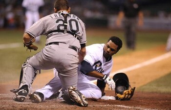 ST PETERSBURG, FL - JUNE 13:  Infielder Willy Aybar #16 of the Tampa Bay Rays topples catcher Matt Treanor #20 the Florida Marlins at Tropicana Field June 13, 2008 in St. Petersburg, Florida.  (Photo by Al Messerschmidt/Getty Images)