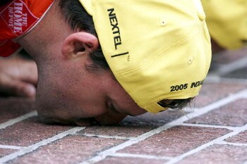INDIANAPOLIS - AUGUST 7: Tony Stewart, driver of the #20 Home Depot Chevrolet, kisses the bricks after winning the NASCAR Nextel Cup Allstate 400 at the Brickyard on August 7, 2005 at Indianapolis Motor Speedway in Indianapolis, Indiana. (Photo By Streete