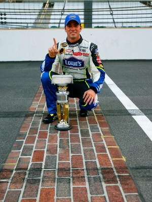 INDIANAPOLIS - AUGUST 06:  Jimmie Johnson, driver of the #48 Lowe's Chevrolet, poses for pictures with the trophy after winning the NASCAR Nextel Cup Series Allstate 400 at the Brickyard on August 6, 2006 at Indianapolis Motor Speedway in Indianapolis, In
