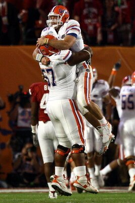 MIAMI - JANUARY 08:  Quarterback Tim Tebow of the Florida Gators celebrates with teammate Carl Johnson #57 after throwing for a touchdown against the Oklahoma Sooners in the FedEx BCS National Championship Game at Dolphin Stadium on January 8, 2009 in Mia