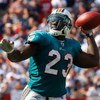 FOXBORO, MA - SEPTEMBER 21: Ronnie Brown #23 of he Miami Dolphins throws a touchdown pass in the third quarter against the New England Patriots at Gillette Stadium on September 21, 2008 in Foxboro, Massachusetts. (Photo by Jim Rogash/Getty Images)