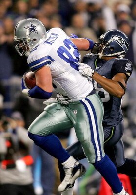 SEATTLE - JANUARY 06:  Michael Boulware #28 of the Seattle Seahawks tries to pull down Jason Witten #82 of the Dallas Cowboys in the second quarter of the NFC Wild Card Playoff Game on January 6, 2007 at Qwest Field in Seattle, Washington.  (Photo by Jona