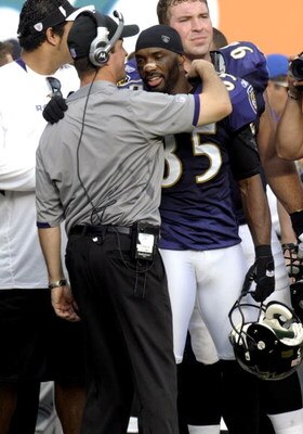 MIAMI, FL - JANUARY 4:  Coach John Harbaugh of the Baltimore Ravens hugs wide receiver Derrick Mason #85 after play against the Miami Dolphins during their AFC Wild Card Game at Dolphins Stadium on January 4, 2009 in Miami, Floirda.  (Photo by Al Messersc