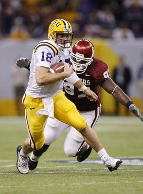 NEW ORLEANS - JANUARY 4:  Quarterback Matt Mauck #18 of LSU scrambles away from defensive tackle Tommie Harris #97 of Oklahoma in the second quarter during the Nokia Sugar Bowl National Championship game on January 4, 2004 at the Louisiana Superdome in Ne