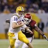 NEW ORLEANS - JANUARY 4:  Quarterback Matt Mauck #18 of LSU scrambles away from defensive tackle Tommie Harris #97 of Oklahoma in the second quarter during the Nokia Sugar Bowl National Championship game on January 4, 2004 at the Louisiana Superdome in Ne