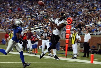 DETROIT - NOVEMBER 09:  Troy Williamson #84 of the Jacksonville Jaguars catches a touchdown pass against Travis Fisher #21 of the Detroit Lions on November 9, 2008 at Ford Field in Detroit, Michigan. Jacksonville defeated Detroit 38-14.  (Photo by Jim McI