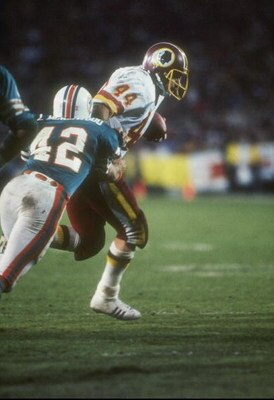 30 Jan 1983:  Defensive lineman Lyle Blackwood #42 of the Miami Dophins lunges at running back John Riggins #44 of the Washington Redskins during the Super Bowl XVII at the Rose Bowl in Pasadena, California.  The Redskins won the game, 27-17. Mandatory Cr