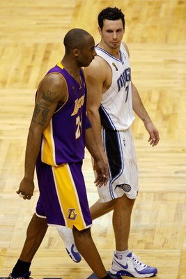 ORLANDO, FL - JUNE 14:  Kobe Bryant #24 of the Los Angeles Lakers and J.J. Redick #7 of the Orlando Magic walk up court in Game Five of the 2009 NBA Finals on June 14, 2009 at Amway Arena in Orlando, Florida.  The Lakers won 99-86.  NOTE TO USER:  User ex