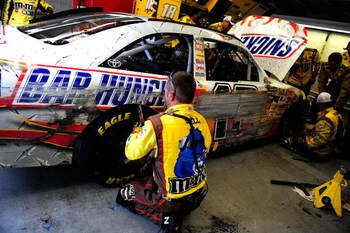 INDIANAPOLIS - JULY 26:  A crew member for the #18 Snickers Toyota driven by Kyle Busch works on the car in the garage during the NASCAR Sprint Cup Series Allstate 400 at the Brickyard at Indianapolis Motor Speedway on July 26, 2009 in Indianapolis, India