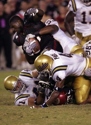 SAN DIEGO - SEPTEMBER 3:  Running back Lynell Hampton #22 of the San Diego State Aztecs is brought down after being stripped of his helmet by defenders Brigham Harwell  #93, Jarrad Page #4, and Spencer Havner #41 the UCLA Bruins on September 3, 2005 at Qu