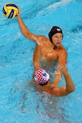 BEIJING - AUGUST 16:  Tony Azevedo of the United States passes over Aljosa Kunac of Croatia during their water polo match at the Ying Tung Natatorium on Day 8 of the Beijing 2008 Olympic Games on August 16, 2008 in Beijing, China.  (Photo by Clive Brunski
